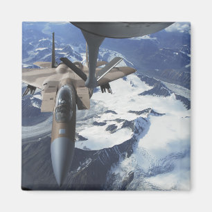 An F-15C Eagle aircraft sits behind a KC-135R Magnet
