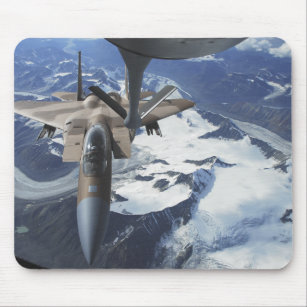 An F-15C Eagle aircraft sits behind a KC-135R Mouse Pad