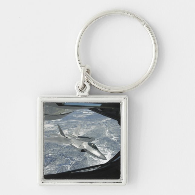 An F-22 Raptor banks away from a KC-135 Key Ring (Front)