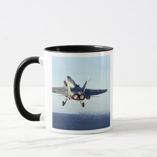 An F/A-18C Hornet launches from the flight deck Mug (Left)