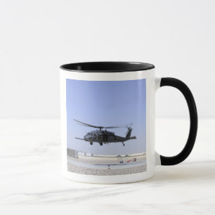An HH-60G Pave Hawk taking off from Camp Bastio Mug
