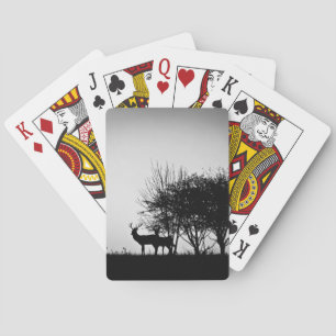 An image of some deer in the morning mist playing cards
