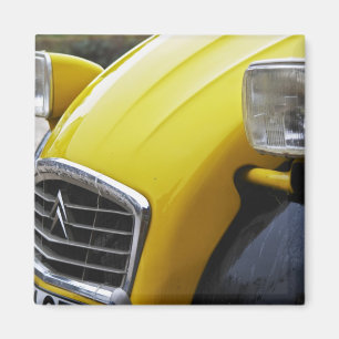 An old black and yellow Citroen 2CV 2 CV, detail Magnet