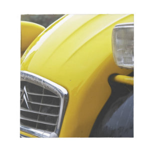 An old black and yellow Citroen 2CV 2 CV, detail Notepad