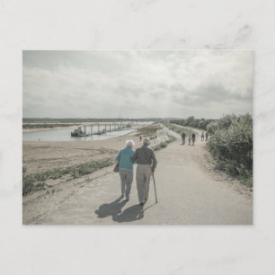 An old couple walking on street postcard