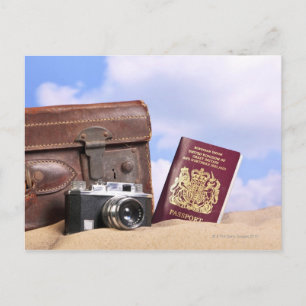 An old leather suitcase, retro camera and postcard