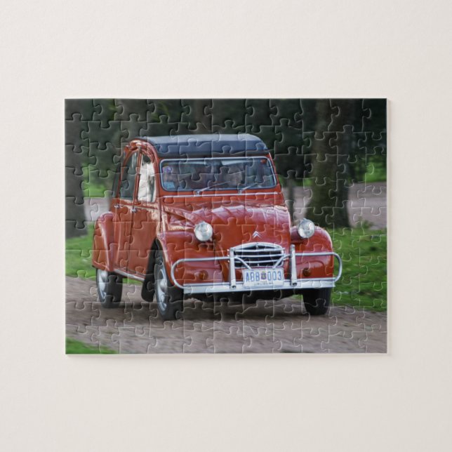An old red Citroen 2CV car with a smiling woman Jigsaw Puzzle (Horizontal)