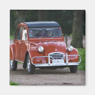 An old red Citroen 2CV car with a smiling woman Magnet
