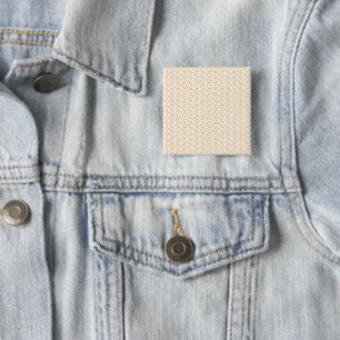 an orange and white background with swirls 15 cm square badge