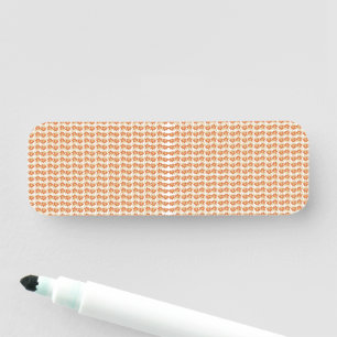an orange and white pattern on a white background name tag
