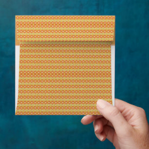 an orange and yellow background with small dots envelope