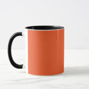 an orange background with a black border mug