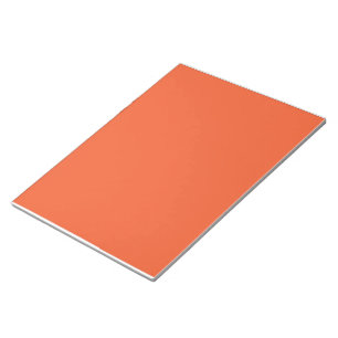 An orange background with a black border notepad