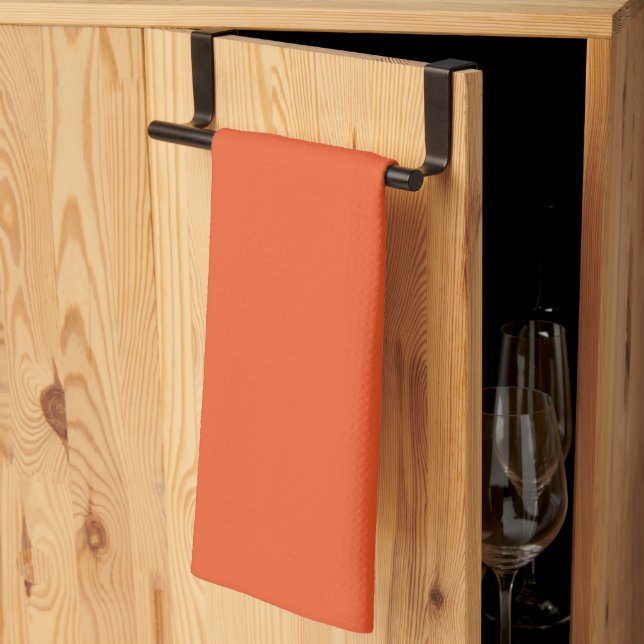 an orange background with a tea towel (Thirds Fold)