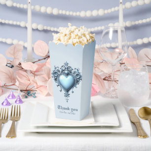 An ornate light blue archway with floral accents, favour box