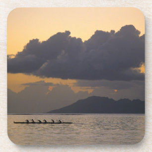 An outrigger canoe team practices off the coast coaster