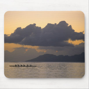An outrigger canoe team practices off the coast mouse pad