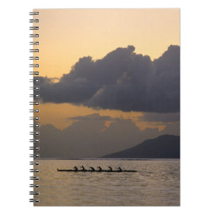 An outrigger canoe team practices off the coast notebook