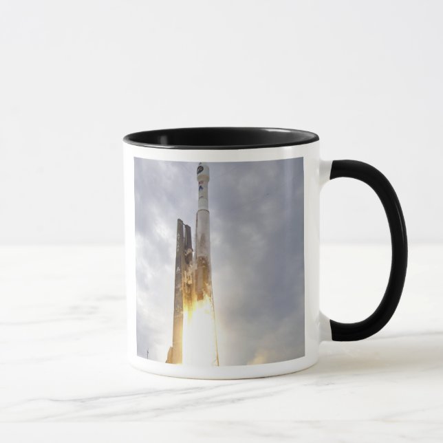 An United Launch Alliance Atlas V rocket lifts Mug (Right)