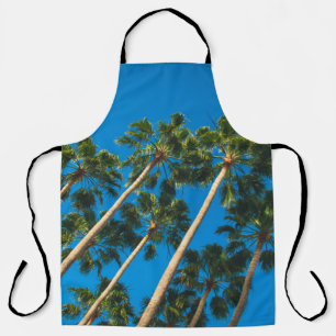 Angle perspective of group of tall thin palm trees apron