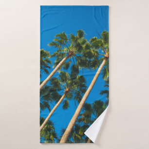Angle perspective of group of tall thin palm trees bath towel