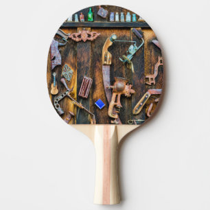Antique collection on wall ping pong paddle