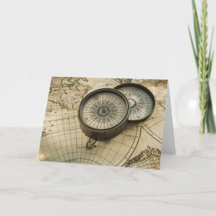 Antique compass on map card