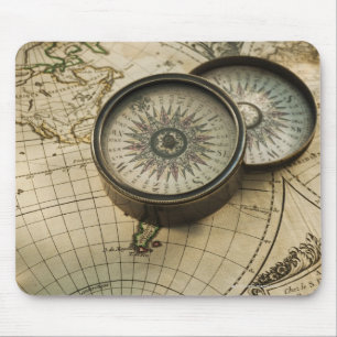 Antique compass on map mouse pad