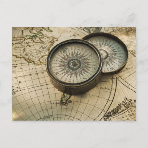 Antique compass on map postcard