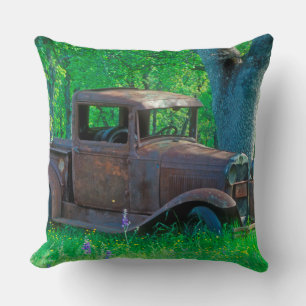 Antique rusted truck in a meadow cushion