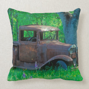 Antique rusted truck in a meadow cushion