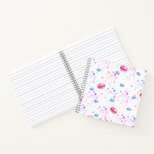 Appetizing macaroons in watercolor splatters notebook