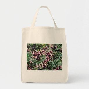 Apples on the grass tote bag