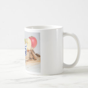 Applesauce with cinnamon in stoneware bowl coffee mug