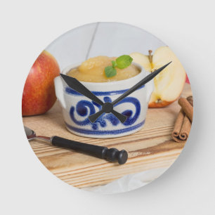Applesauce with cinnamon in stoneware bowl round clock