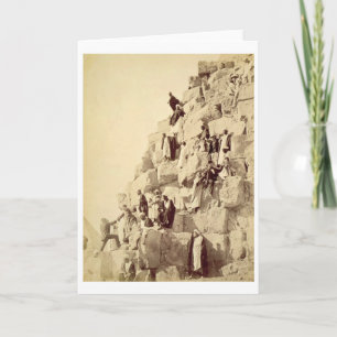 Arabs assisting tourists to climb the pyramids at card