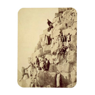 Arabs assisting tourists to climb the pyramids at magnet