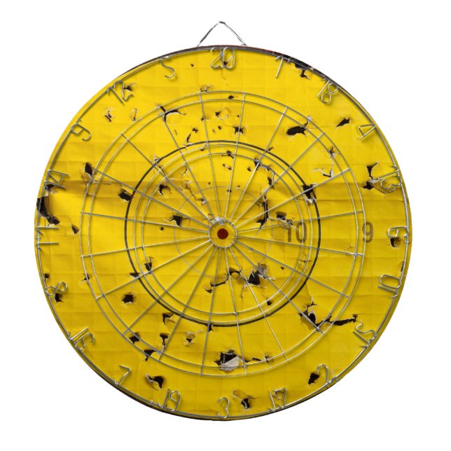 Archery target close up with many arrow holes dartboard (Front)