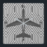Art Deco Aeroplane, Graphite and Silver Grey Square Wall Clock<br><div class="desc">Clock as an Art Deco inspired concept of a futuristic plane,  in a striped,  silky gradient of silver to deep graphite grey / grey,  against  a light and deep silver grey,  Deco background</div>