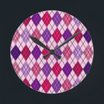 Art Deco Argyle  Round Clock<br><div class="desc">This wall clock has an art deco design of diamond shapes made from overlapping angles in black lines coloured in shades of purple and pink with diagonal black lines making the design look like argyle</div>