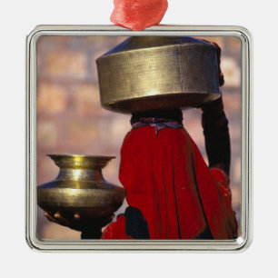 Asia, India, Rajasthan. A local woman in a red Metal Tree Decoration