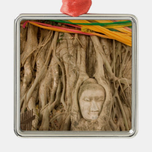 Asia, Thailand, Siam, Buddha in tree ruts at Metal Ornament