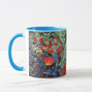 Aspen leaf on a lichen covered rock mug
