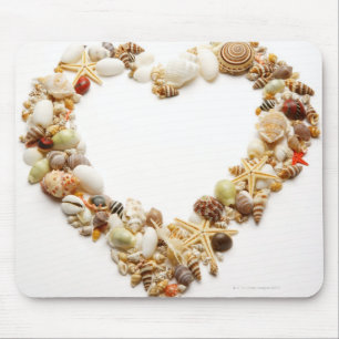 Assorted seashells form heart shape mouse pad