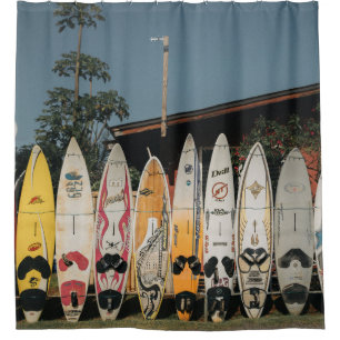 Assorted surfing boards stands on open field in th shower curtain