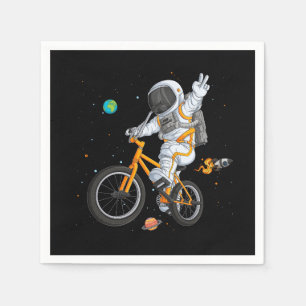 astronaut in spacesuit riding bmx bike on space ov napkin