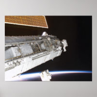 Astronauts work on the International Space Station