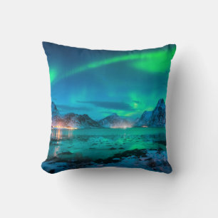 Aurora borealis over the sea coast, snowy mountain cushion