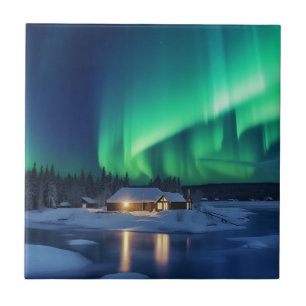 Aurora borealis over winter cabin ceramic tile