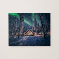 Aurora borealis over winter cabin